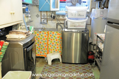 Laundry room with appliances and baskets. 