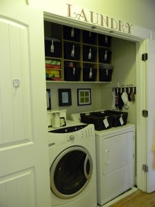 Laundry closet with labeled baskets. 