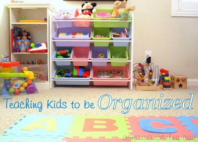 Toys organized in bins and shelves. Teaching kid to be organized.