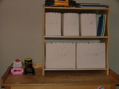 2 level shelf with fabric baskets and books. 