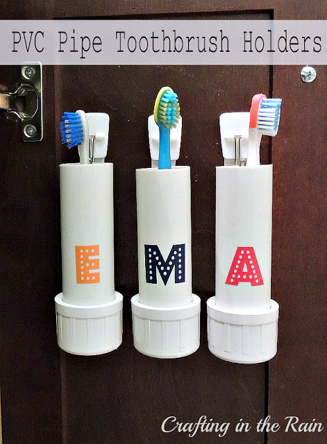 PCV pipe toothbrush holders attached to the wall decorated with initials: E, M, and A. Crafting in the rain.