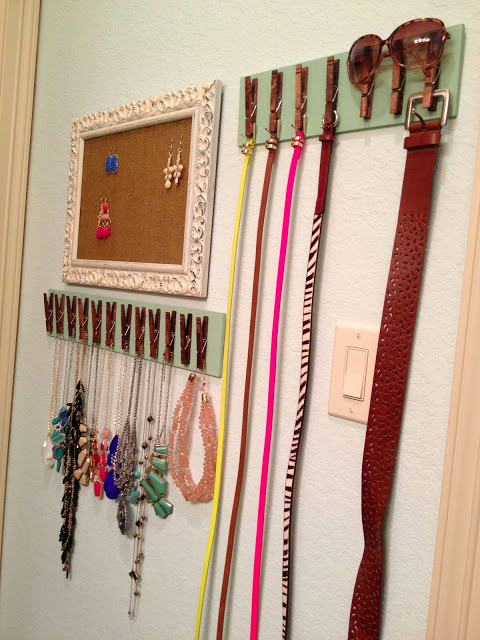 Belts and jewelry on DIY rack made with clothes pins. Framed corkboard used for displaying earings. 