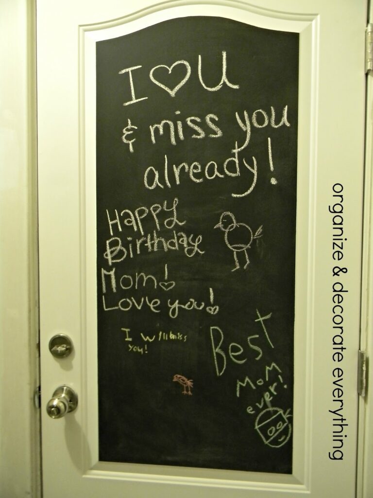 Door with chalkboard painted inset with chalk writing. Organize and decorate everything.