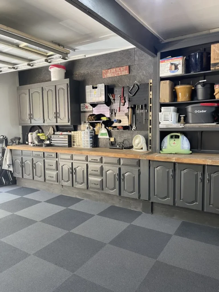 Garage storage using upper and lower cabinets, shelves and a pegboard.