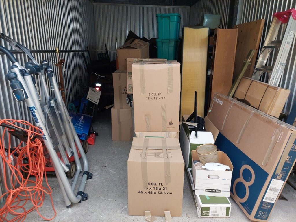 Storage unit filled with boxes, totes and household goods. 