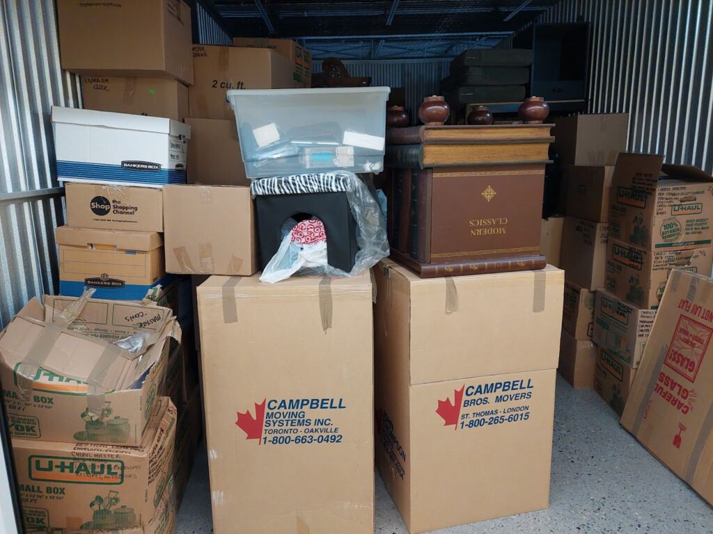 Storage unit filled with totes and cardboard boxes. 