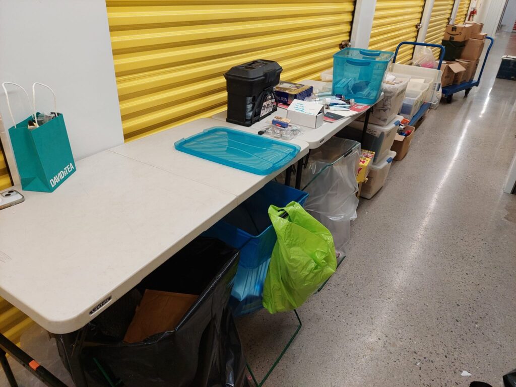 Tables and carts in storage unit hallway. 