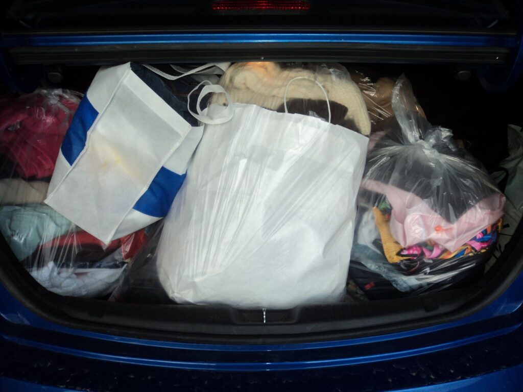 Bagged clothing in the trunk of a car.